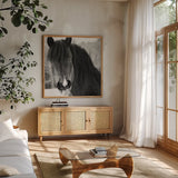 Winter Horse II by Nathan Larson. Shown in a natural wood frame in a cozy modern living room. Available as an archival giclee rolled canvas, fine art paper, or poster print. SKU 76535a.