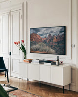 Zion National Park Storms by Nathan Larson. shown as a framed stretched canvas in a living room above a console. Available as a archival giclee rolled canvas, fine art paper, or poster print. SKU 95629i.