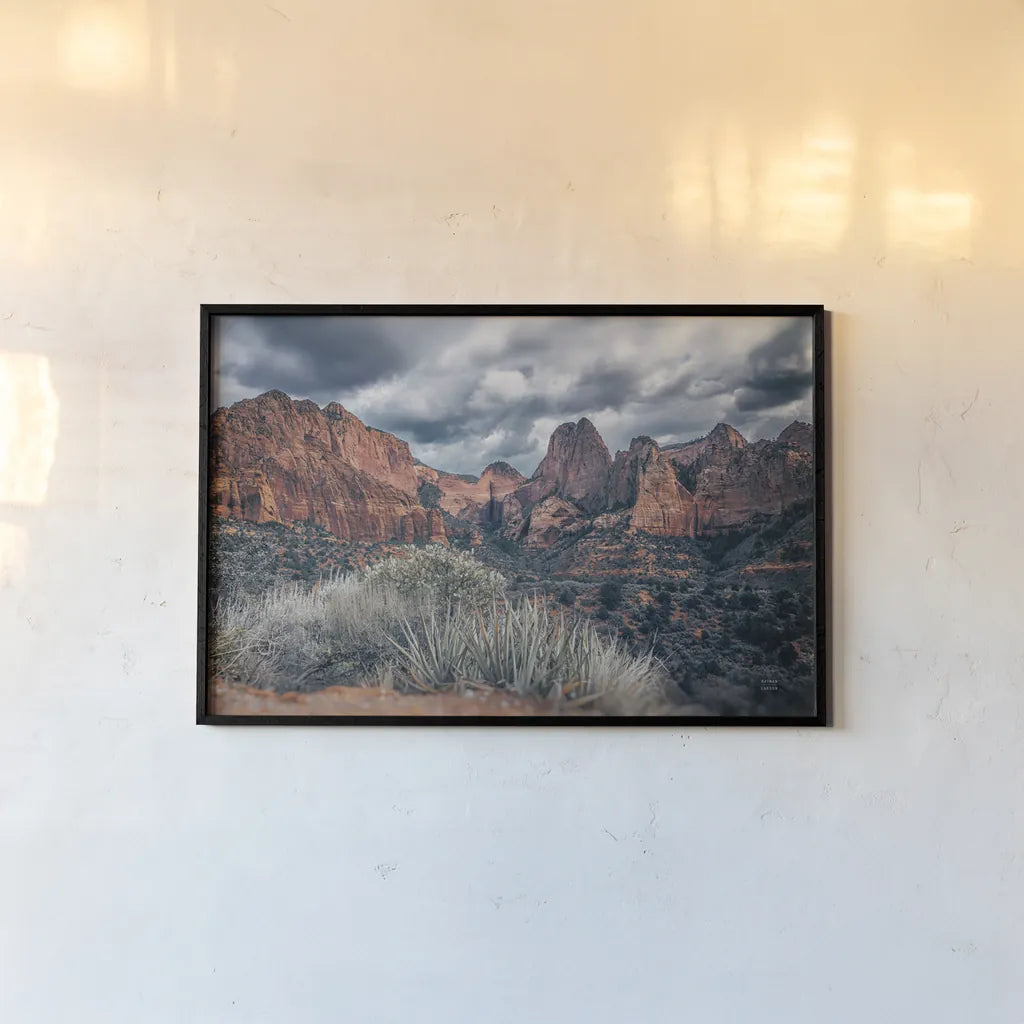 Zion National Park Storms by Nathan Larson. shown as a paper print in a black flame. Available as a archival giclee rolled canvas, fine art paper, or poster print. SKU 95629i.