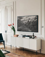Zion National Park Storms BW by Nathan Larson. shown as a framed stretched canvas in a living room above a console. Available as a archival giclee rolled canvas, fine art paper, or poster print. SKU 95630i.