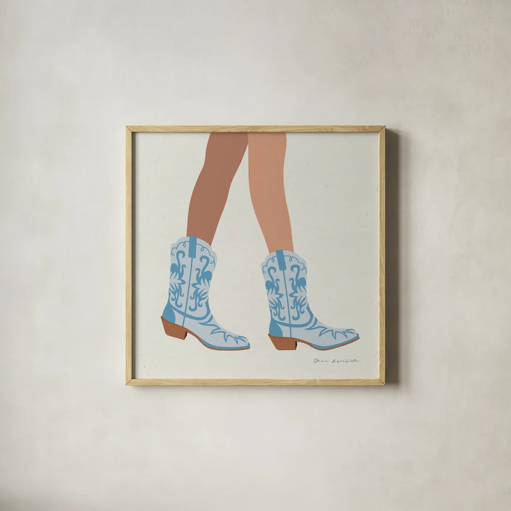Cowgirly I Blue by Omar Escalante. Shown in a natural wood glass frame for a timeless modern aesthetic. Available as an archival giclee rolled canvas, fine art paper, or poster print. SKU 89333a.