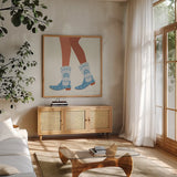Cowgirly II Blue by Omar Escalante. Shown in a natural wood frame in a cozy modern living room. Available as an archival giclee rolled canvas, fine art paper, or poster print. SKU 89334a.