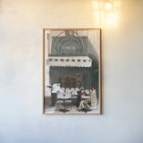 Paris Bistro by Omar Escalante. shown as a paper print in a natural frame. Available as a archival giclee rolled canvas, fine art paper, or poster print. SKU 71213h.