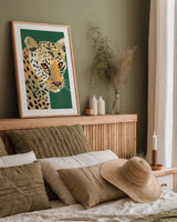 Colorful Cheetah on Emerald by Pamela Munger. shown as a paper print in a natural frame. Available as a archival giclee rolled canvas, fine art paper, or poster print. SKU 76923h.