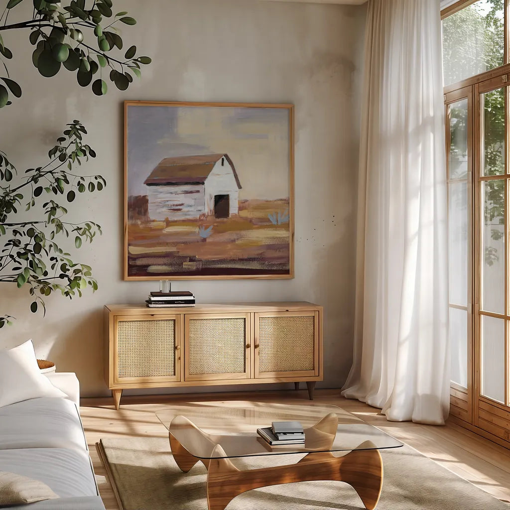 Little White Barn by Pamela Munger. Shown in a natural wood frame in a cozy modern living room. Available as an archival giclee rolled canvas, fine art paper, or poster print. SKU 70681a.