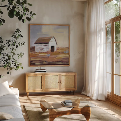 Little White Barn by Pamela Munger. Shown in a natural wood frame in a cozy modern living room. Available as an archival giclee rolled canvas, fine art paper, or poster print. SKU 70681a.
