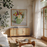 Spring in a Green Pitcher by Pamela Munger. Shown in a natural wood frame in a cozy modern living room. Available as an archival giclee rolled canvas, fine art paper, or poster print. SKU 77775a.
