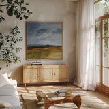 Storm Over Buckhorn by Pamela Munger. Shown in a natural wood frame in a cozy modern living room. Available as an archival giclee rolled canvas, fine art paper, or poster print. SKU 87348a.