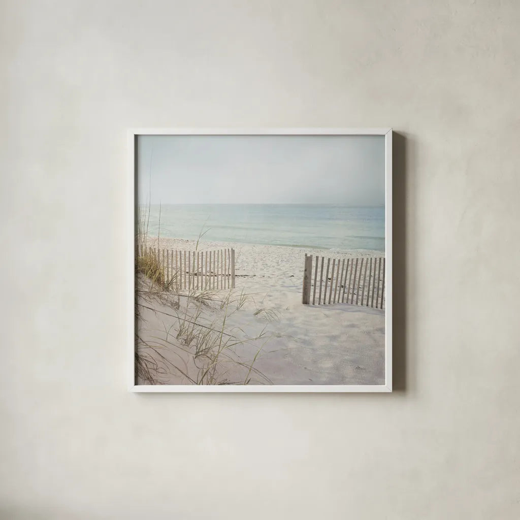 Beach Fence by Pela Studio. Shown in a crisp white glass frame for a clean and minimalist style. Available as an archival giclee rolled canvas, fine art paper, or poster print. SKU 76252a.