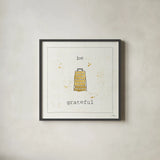 Cuisine Cuties Be Grateful by Pela Studio. Shown in a sleek black glass frame for a contemporary gallery look. Available as an archival giclee rolled canvas, fine art paper, or poster print. SKU 28477a.