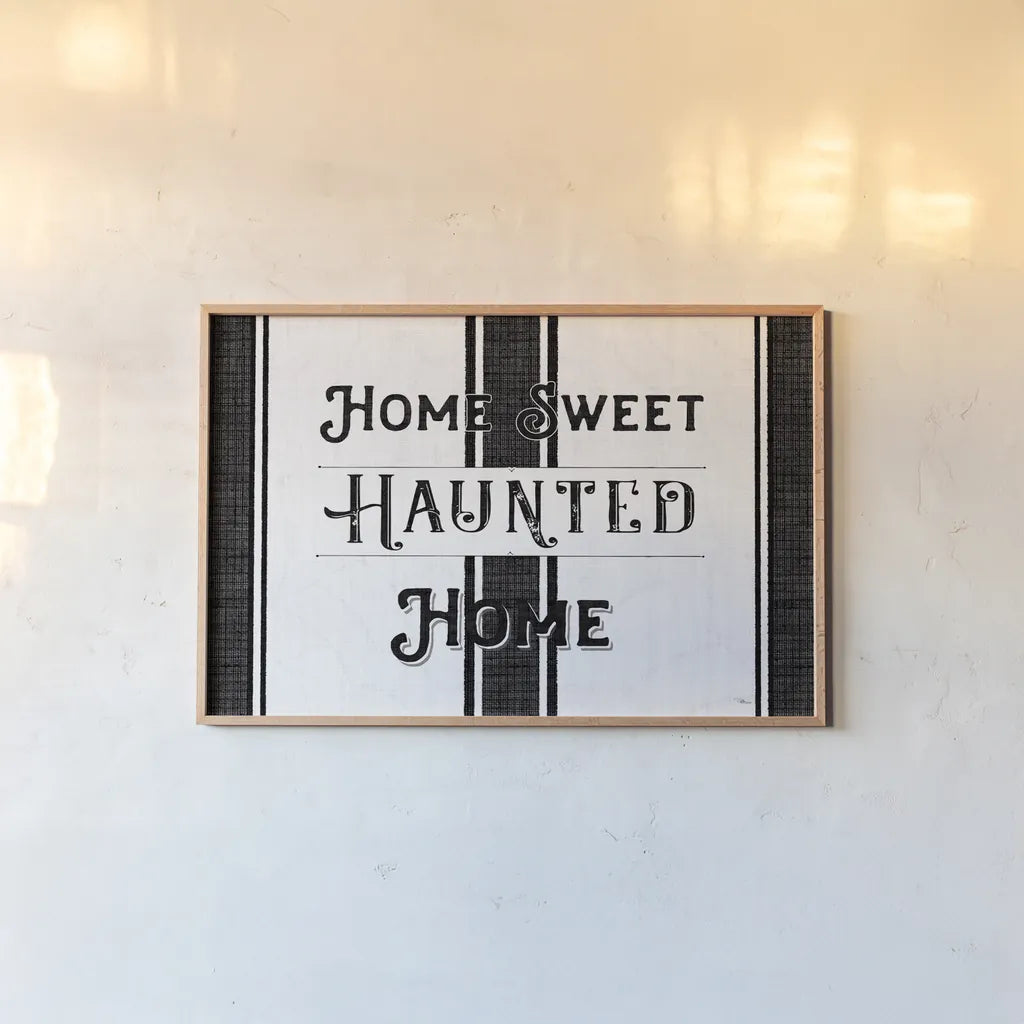 Home Sweet Haunted Home BW by Pela Studio. shown as a paper print in a natural frame. Available as a archival giclee rolled canvas, fine art paper, or poster print. SKU 68426i.