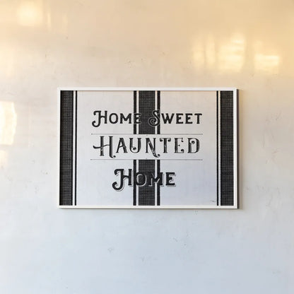 Home Sweet Haunted Home BW by Pela Studio. shown as a paper print in a white frame. Available as a archival giclee rolled canvas, fine art paper, or poster print. SKU 68426i.