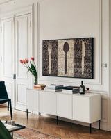 Kitchen Words Trio by Pela Studio. shown as a framed stretched canvas in a living room above a console. Available as a archival giclee rolled canvas, fine art paper, or poster print. SKU 7317i.