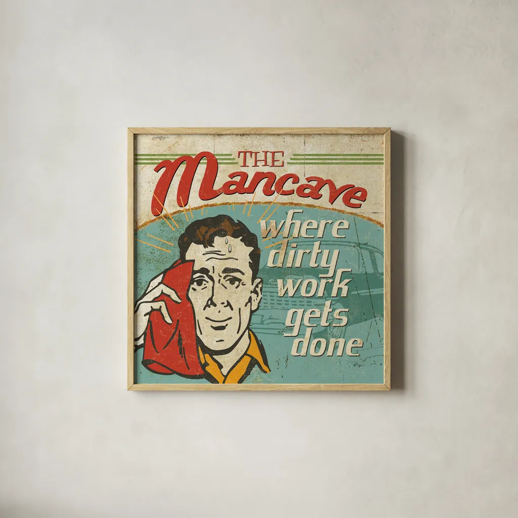 Mancave III - Where Dirty Work Gets Done by Pela Studio. Shown in a natural wood glass frame for a timeless modern aesthetic. Available as an archival giclee rolled canvas, fine art paper, or poster print. SKU 10313a.