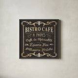Parisian Signs Square II no Border by Pela Studio. Shown in a sleek black glass frame for a contemporary gallery look. Available as an archival giclee rolled canvas, fine art paper, or poster print. SKU 13468a.