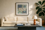 Santorini I Love by Pela Studio. Displayed in a glass frame with matte in a clean modern living room. Available as an archival giclee rolled canvas, fine art paper, or poster print. SKU 12150a.