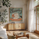 The Cleaners II by Pela Studio. Shown in a natural wood frame in a cozy modern living room. Available as an archival giclee rolled canvas, fine art paper, or poster print. SKU 14795a.