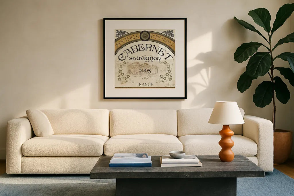 Wine Labels I by Pela Studio. Displayed in a glass frame with matte in a clean modern living room. Available as an archival giclee rolled canvas, fine art paper, or poster print. SKU 12859a.
