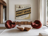 Wine Labels IV by Pela Studio. Shown as extra-large giant wall art in a modern living room. Available as an archival giclee rolled canvas, fine art paper, or poster print. SKU 12862a.