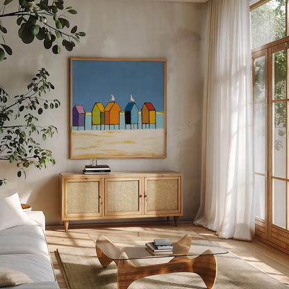 Cabanas II by Phyllis Adams. Shown in a natural wood frame in a cozy modern living room. Available as an archival giclee rolled canvas, fine art paper, or poster print. SKU 37285a.