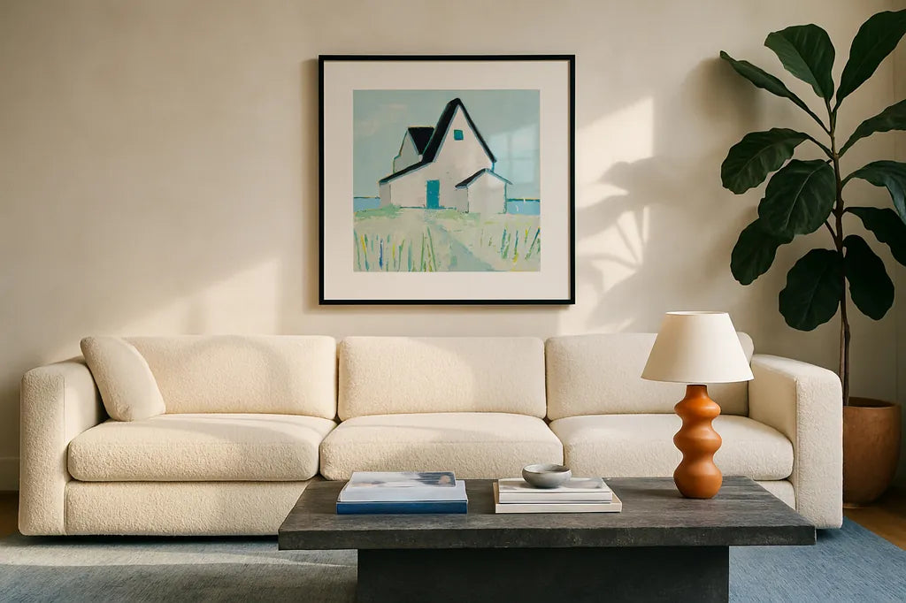Cottage by the Sea by Phyllis Adams. Displayed in a glass frame with matte in a clean modern living room. Available as an archival giclee rolled canvas, fine art paper, or poster print. SKU 27247a.