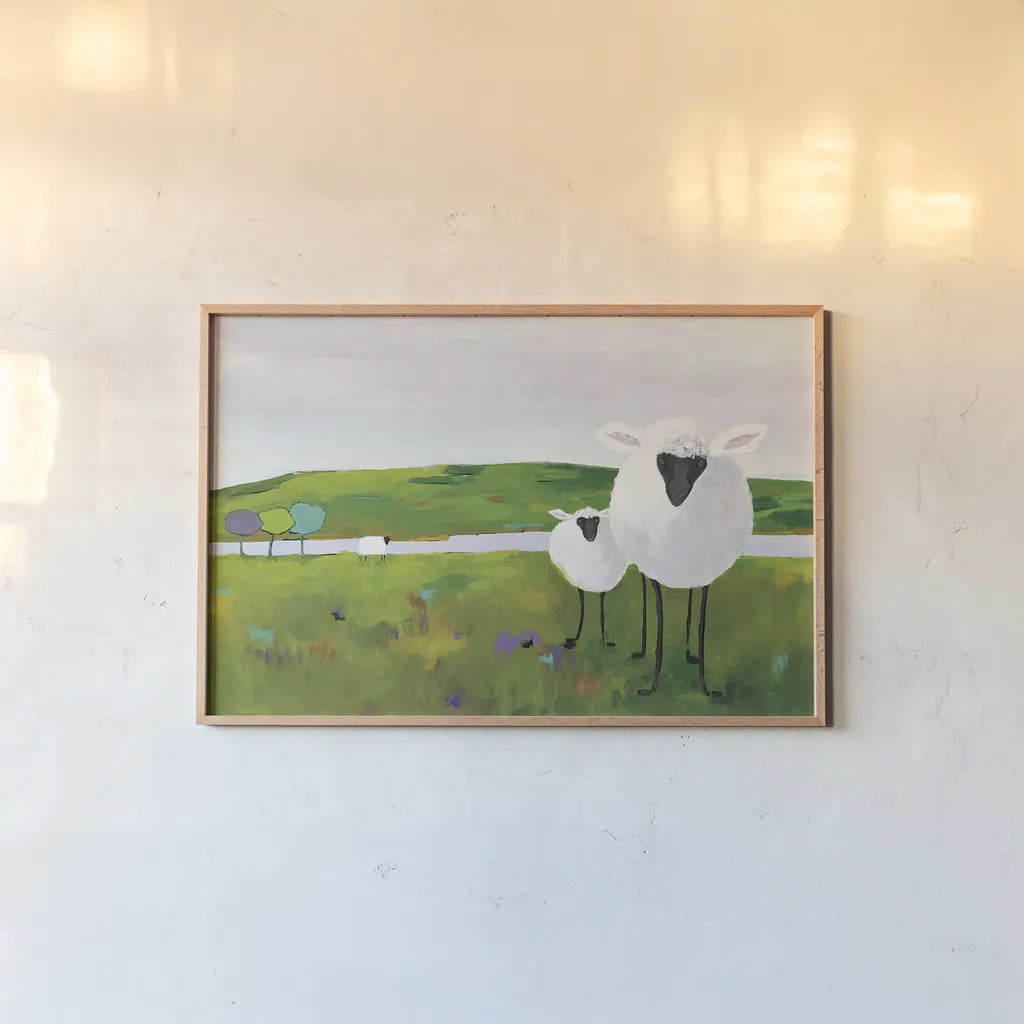 Sheep in the Meadow by Phyllis Adams. shown as a paper print in a natural frame. Available as a archival giclee rolled canvas, fine art paper, or poster print. SKU 27254i.