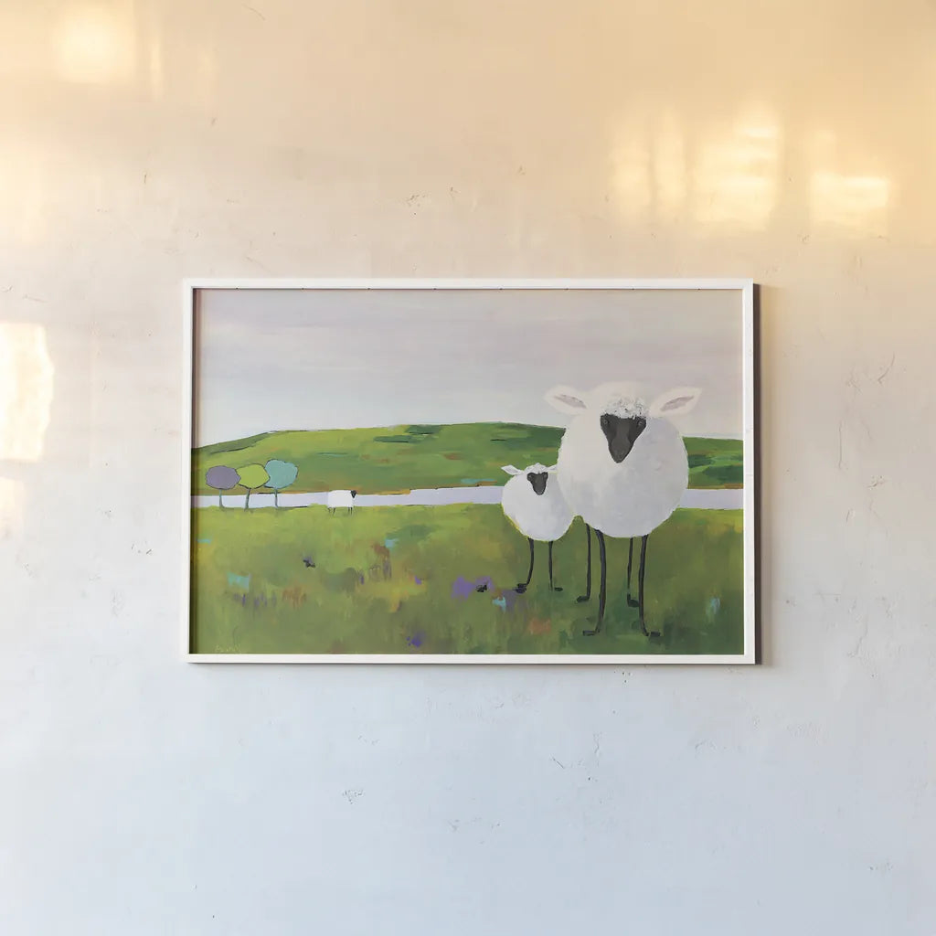 Sheep in the Meadow by Phyllis Adams. shown as a paper print in a white frame. Available as a archival giclee rolled canvas, fine art paper, or poster print. SKU 27254i.