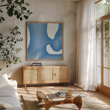 Batik Blue II by Piper Rhue. Shown in a natural wood frame in a cozy modern living room. Available as an archival giclee rolled canvas, fine art paper, or poster print. SKU 32795a.