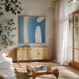 Batik Blue IV by Piper Rhue. Shown in a natural wood frame in a cozy modern living room. Available as an archival giclee rolled canvas, fine art paper, or poster print. SKU 34420a.