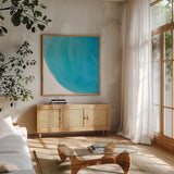 Pools of Turquoise IV by Piper Rhue. Shown in a natural wood frame in a cozy modern living room. Available as an archival giclee rolled canvas, fine art paper, or poster print. SKU 34932a.