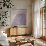 Swish of Magenta I by Piper Rhue. Shown in a natural wood frame in a cozy modern living room. Available as an archival giclee rolled canvas, fine art paper, or poster print. SKU 34926a.