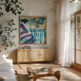 City Graffiti II by Roque Silva. Shown in a natural wood frame in a cozy modern living room. Available as an archival giclee rolled canvas, fine art paper, or poster print. SKU 62419a.