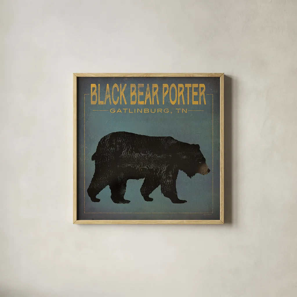 Black Bear Porter by Ryan Fowler. Shown in a natural wood glass frame for a timeless modern aesthetic. Available as an archival giclee rolled canvas, fine art paper, or poster print. SKU 30843a.