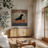 Black Dog Canoe by Ryan Fowler. Shown in a natural wood frame in a cozy modern living room. Available as an archival giclee rolled canvas, fine art paper, or poster print. SKU 12501a.