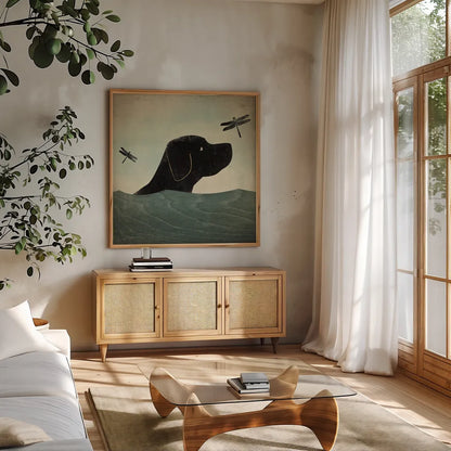 Black Dog Swim by Ryan Fowler. Shown in a natural wood frame in a cozy modern living room. Available as an archival giclee rolled canvas, fine art paper, or poster print. SKU 15624a.