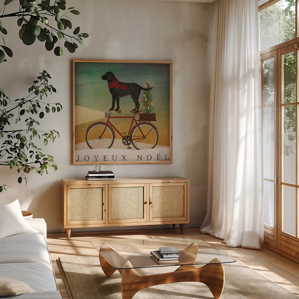 Black Lab on Bike Christmas by Ryan Fowler. Shown in a natural wood frame in a cozy modern living room. Available as an archival giclee rolled canvas, fine art paper, or poster print. SKU 31272a.