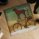 Brown Lab on Bike Christmas by Ryan Fowler. Shown as a detailed flat fine art print, highlighting archival giclee quality. Available as an archival giclee rolled canvas, fine art paper, or poster print. SKU 31273a.