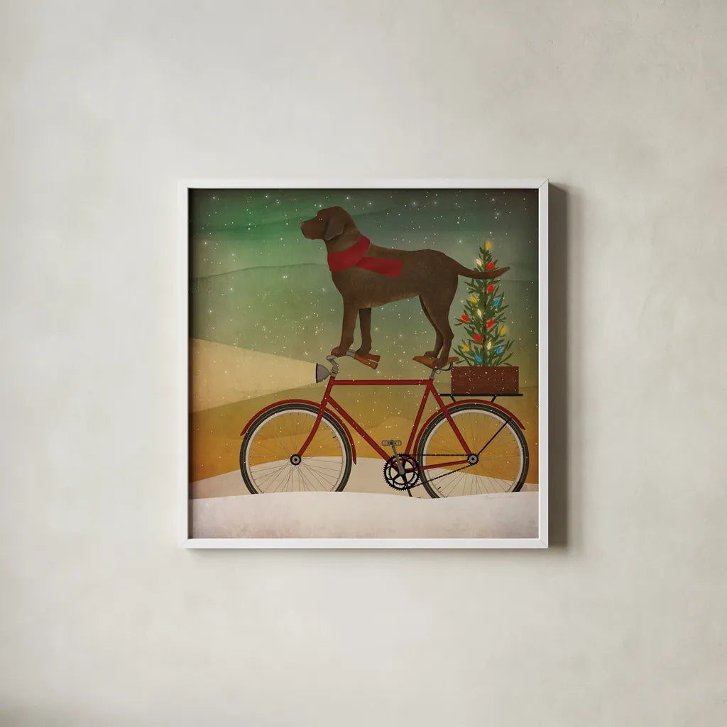 Brown Lab on Bike Christmas by Ryan Fowler. Shown in a crisp white glass frame for a clean and minimalist style. Available as an archival giclee rolled canvas, fine art paper, or poster print. SKU 31273a.