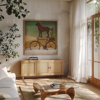 Brown Lab on Bike Christmas by Ryan Fowler. Shown in a natural wood frame in a cozy modern living room. Available as an archival giclee rolled canvas, fine art paper, or poster print. SKU 31273a.
