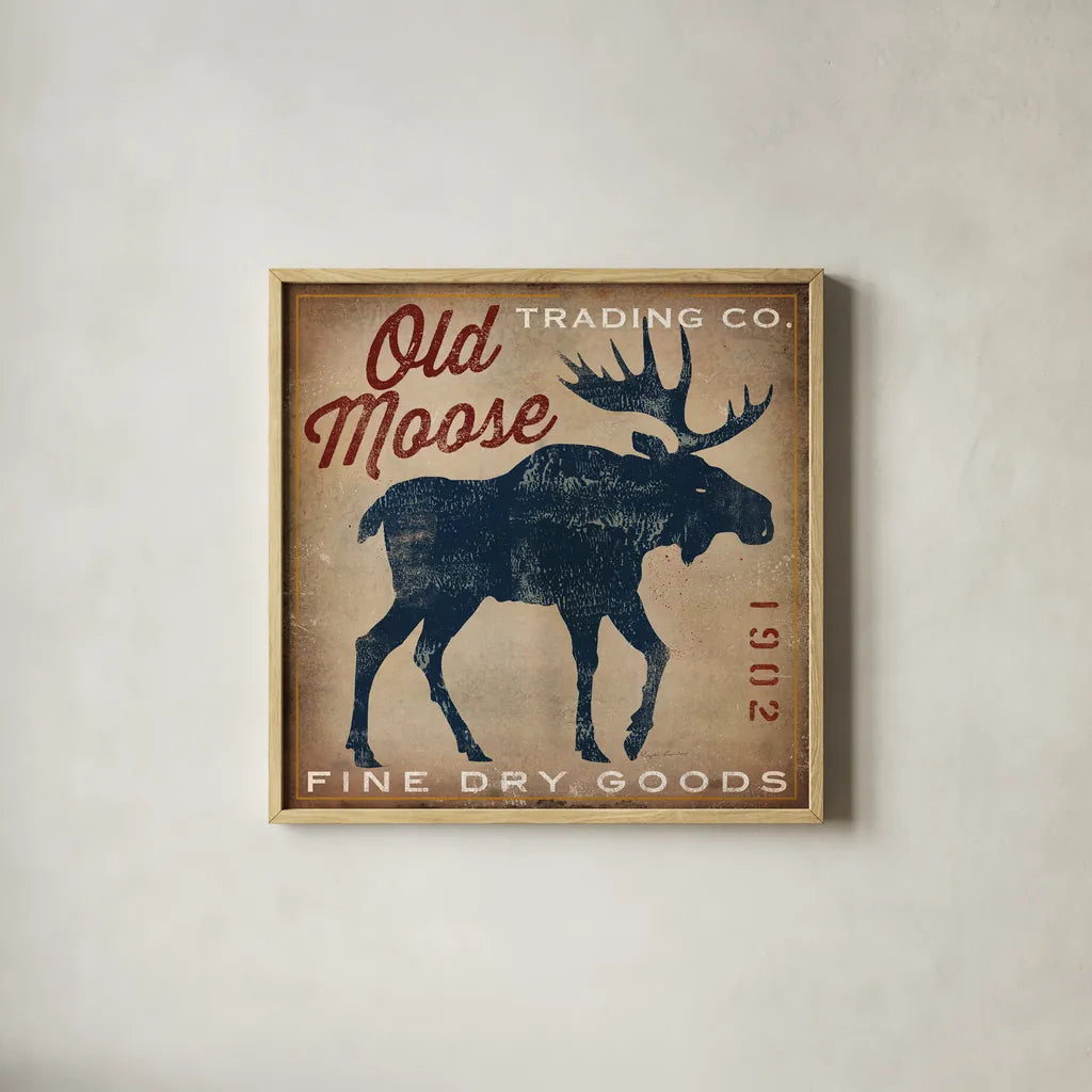 Old Moose Trading Co Tan - Dry Goods by Ryan Fowler. Shown in a natural wood glass frame for a timeless modern aesthetic. Available as an archival giclee rolled canvas, fine art paper, or poster print. SKU 35413a.