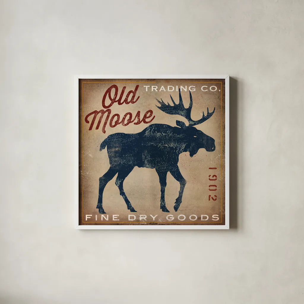 Old Moose Trading Co Tan - Dry Goods by Ryan Fowler. Shown in a crisp white glass frame for a clean and minimalist style. Available as an archival giclee rolled canvas, fine art paper, or poster print. SKU 35413a.