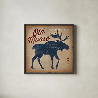 Old Moose Trading Co Tan by Ryan Fowler. Shown in a sleek black glass frame for a contemporary gallery look. Available as an archival giclee rolled canvas, fine art paper, or poster print. SKU 12858a.