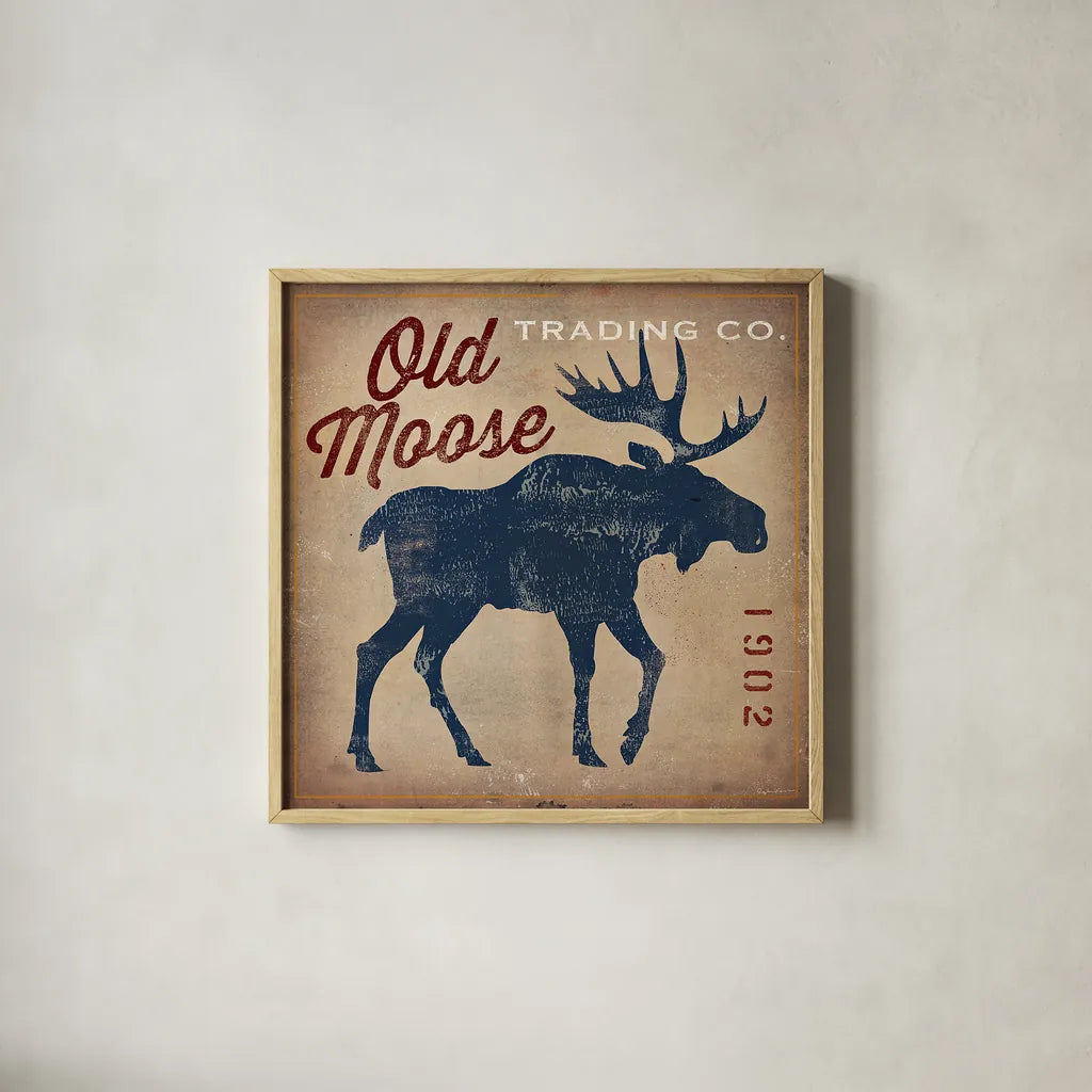 Old Moose Trading Co Tan by Ryan Fowler. Shown in a natural wood glass frame for a timeless modern aesthetic. Available as an archival giclee rolled canvas, fine art paper, or poster print. SKU 12858a.
