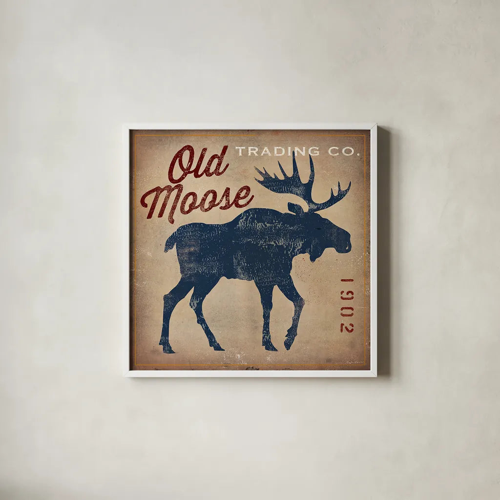 Old Moose Trading Co Tan by Ryan Fowler. Shown in a crisp white glass frame for a clean and minimalist style. Available as an archival giclee rolled canvas, fine art paper, or poster print. SKU 12858a.