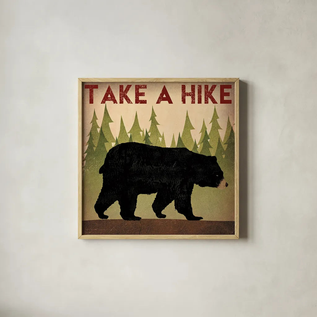 Take a Hike Black Bear by Ryan Fowler. Shown in a natural wood glass frame for a timeless modern aesthetic. Available as an archival giclee rolled canvas, fine art paper, or poster print. SKU 22891a.