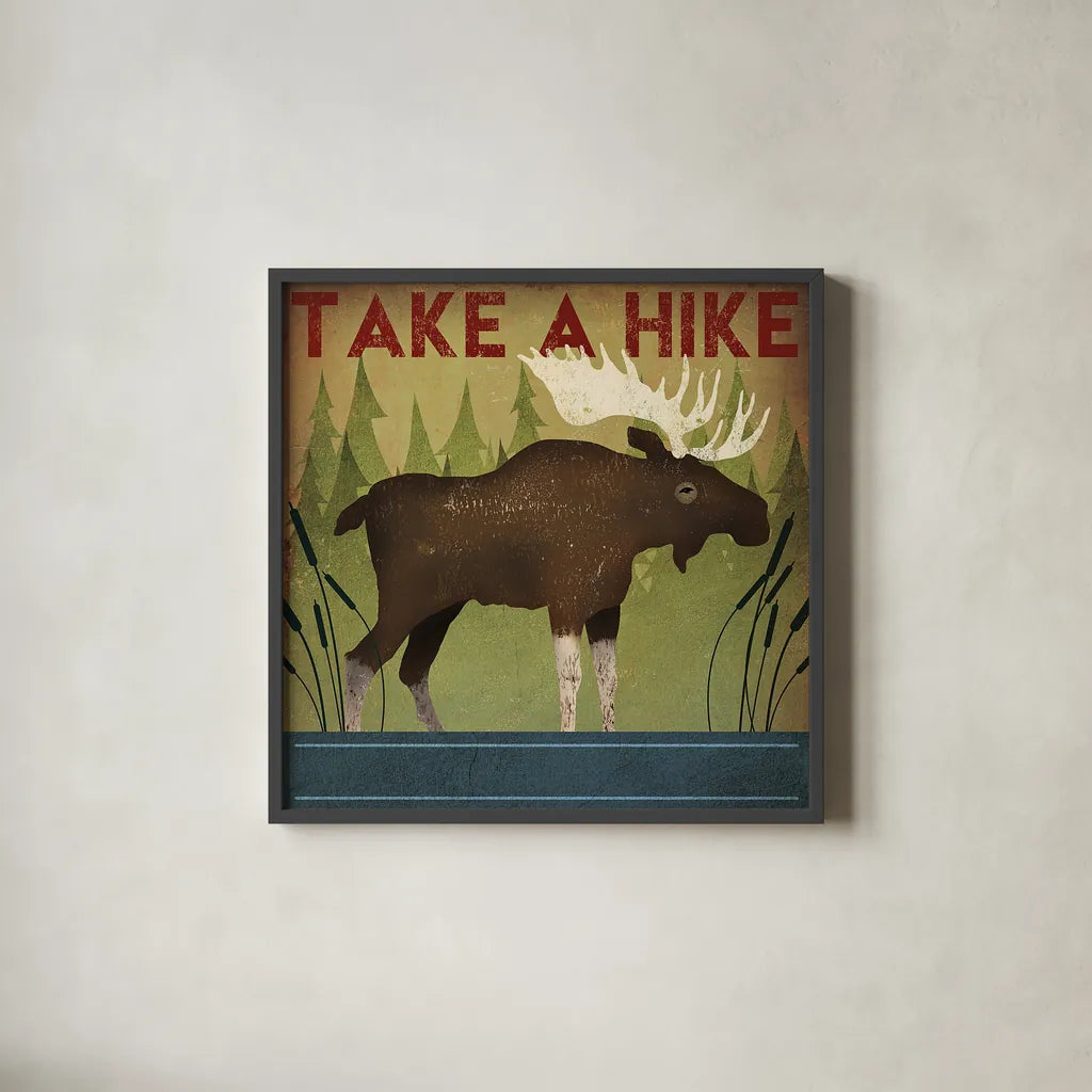 Take a Hike Moose by Ryan Fowler. Shown in a sleek black glass frame for a contemporary gallery look. Available as an archival giclee rolled canvas, fine art paper, or poster print. SKU 22892a.