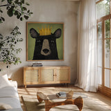 The Black Bear with Crown by Ryan Fowler. Shown in a natural wood frame in a cozy modern living room. Available as an archival giclee rolled canvas, fine art paper, or poster print. SKU 35511a.