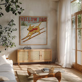 Yellow Dog Ski Co by Ryan Fowler. Shown in a natural wood frame in a cozy modern living room. Available as an archival giclee rolled canvas, fine art paper, or poster print. SKU 13237a.