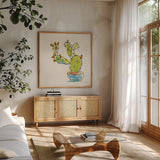 Cacti Garden V by Sara Zieve Miller. Shown in a natural wood frame in a cozy modern living room. Available as an archival giclee rolled canvas, fine art paper, or poster print. SKU 57358a.
