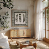 Geo Feathers Square II by Sara Zieve Miller. Shown in a natural wood frame in a cozy modern living room. Available as an archival giclee rolled canvas, fine art paper, or poster print. SKU 18247a.